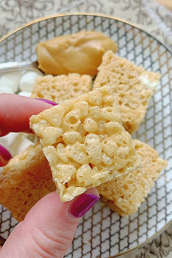 holding a peanut butter rice krispie treat for a close up