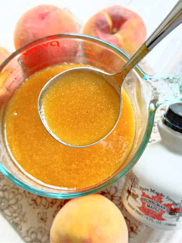 a ladle full of homemade peach syrup