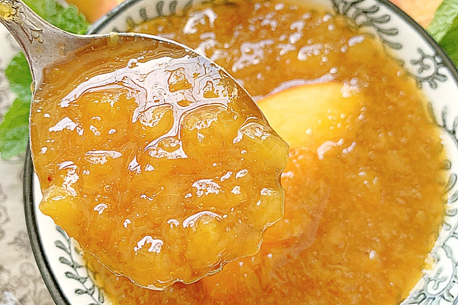 close up of spoonful of peach syrup