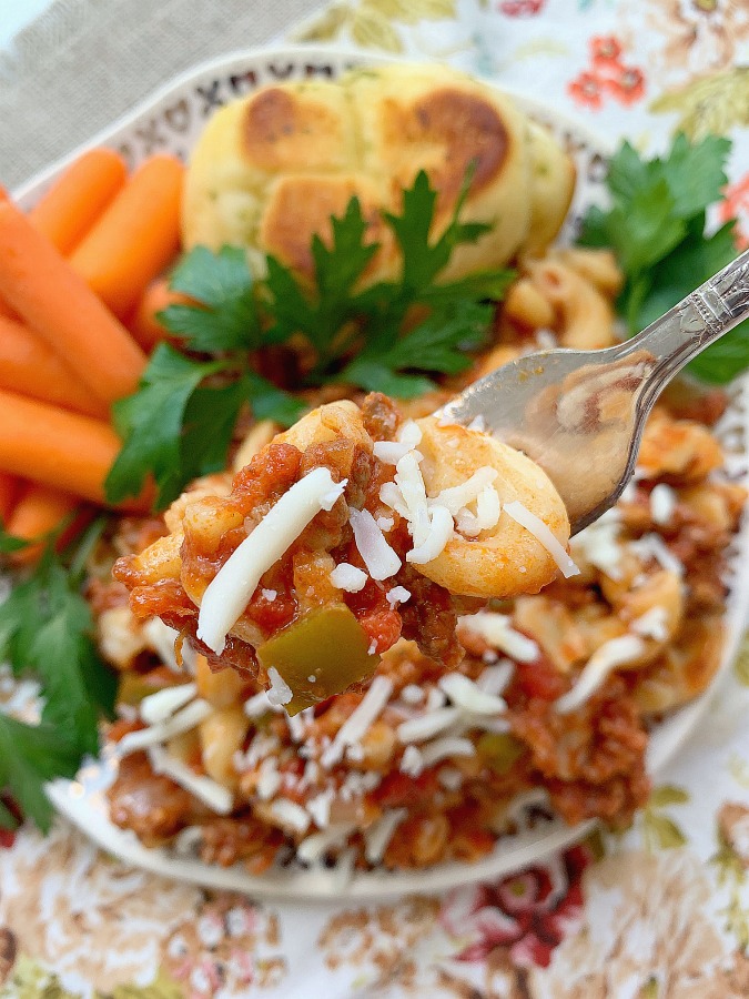 taking a bite of slow cooker beef goulash