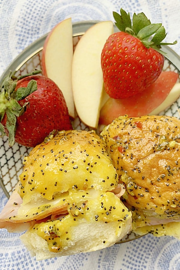 Hawaiian Sweet Roll Sliders on a plate with fruit