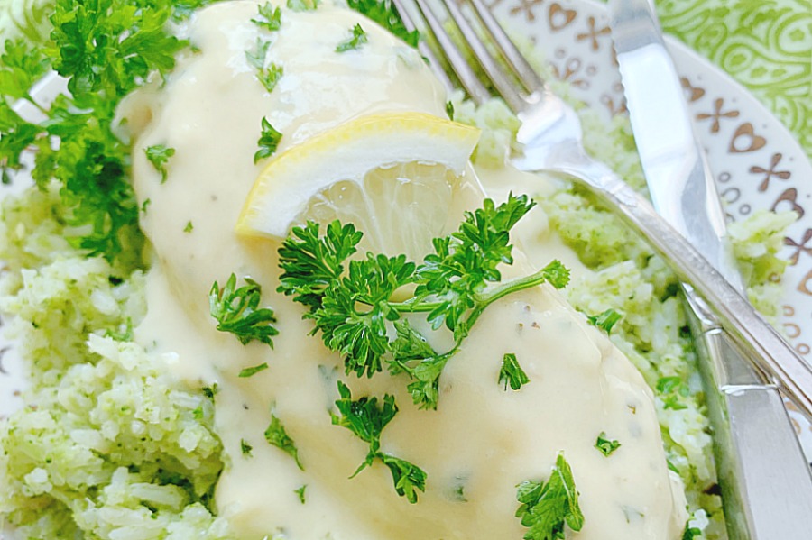 horizontal crop of creamy lemon chicken on a plate with broccoli rice