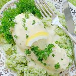 lemon chicken on a plate with broccoli rice and creamy sauce