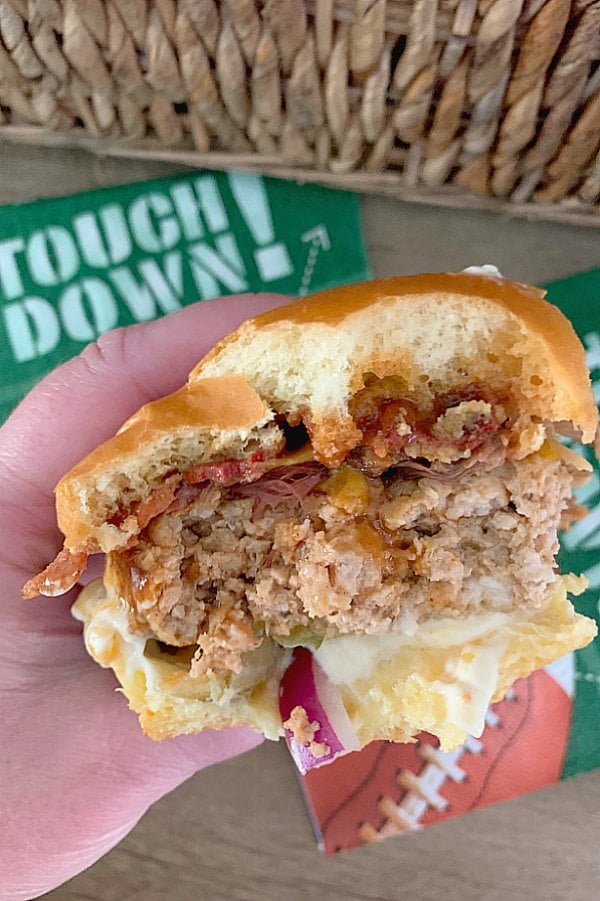 taking a bite of pulled pork burger