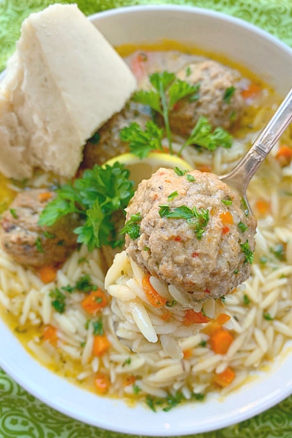 taking a bite of a meatball from easy italian wedding soup