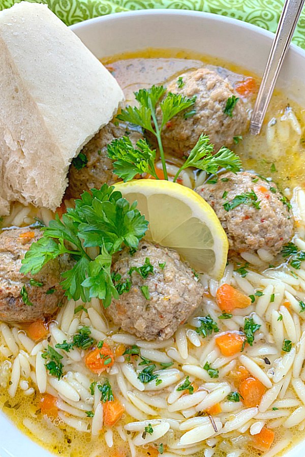 close up view of italian wedding soup with crusty bread