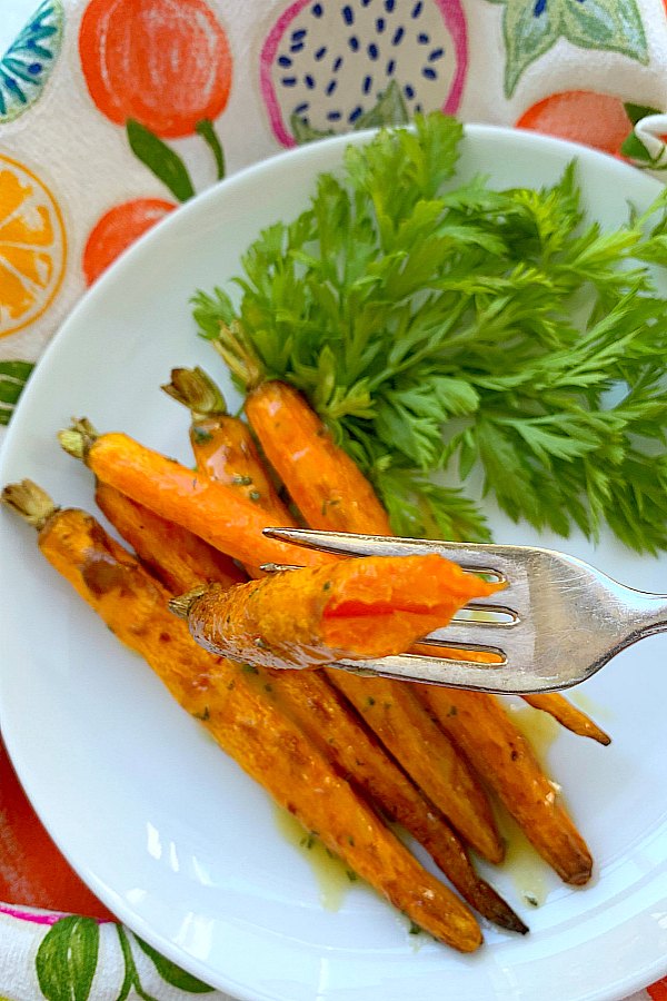 taking a bite of an air fryer carrot