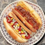 air fryer hot dogs with toasted buns plated and topped two ways