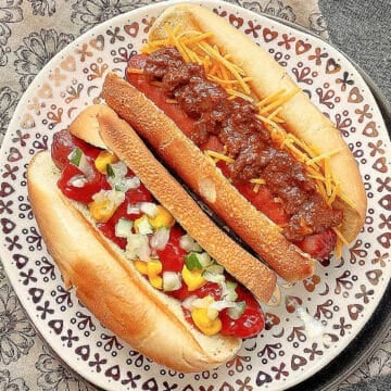 air fryer hot dogs with toasted buns plated and topped two ways