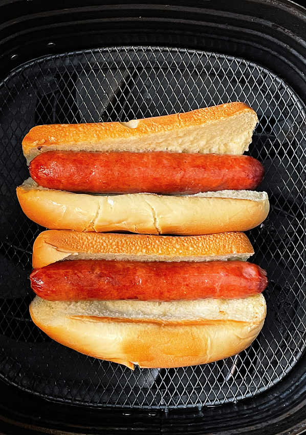 air fryer hot dogs and buns in the basket of the air fryer