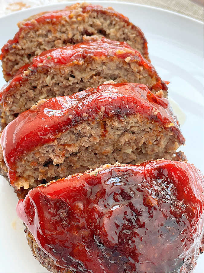 glazed air fryer meatloaf sliced on a plate