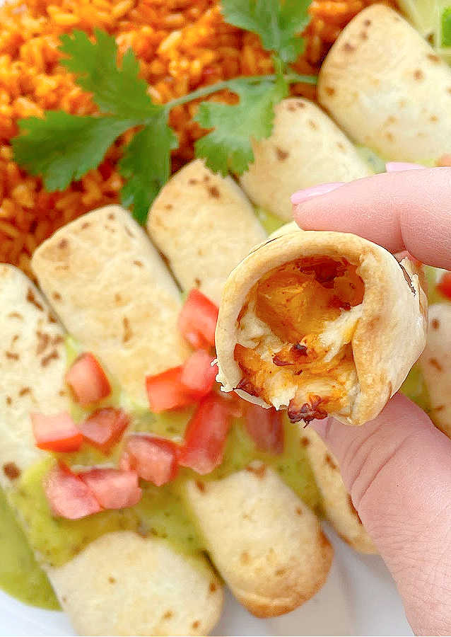 taking a bite of air fryer chicken taquito