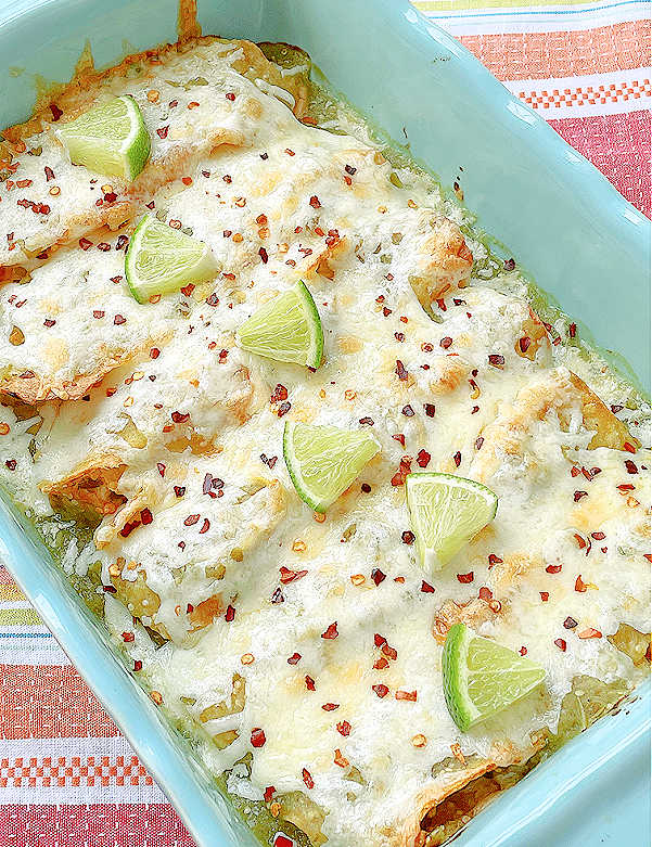 enchiladas in the baking dish topped with lime slices