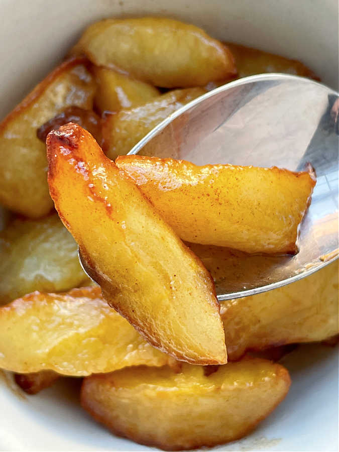 two air fryer apple slices in a spoon