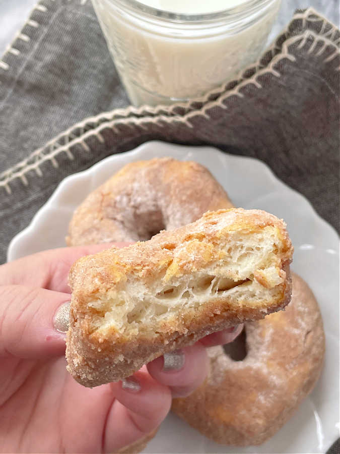 taking a bite of an air fryer donut