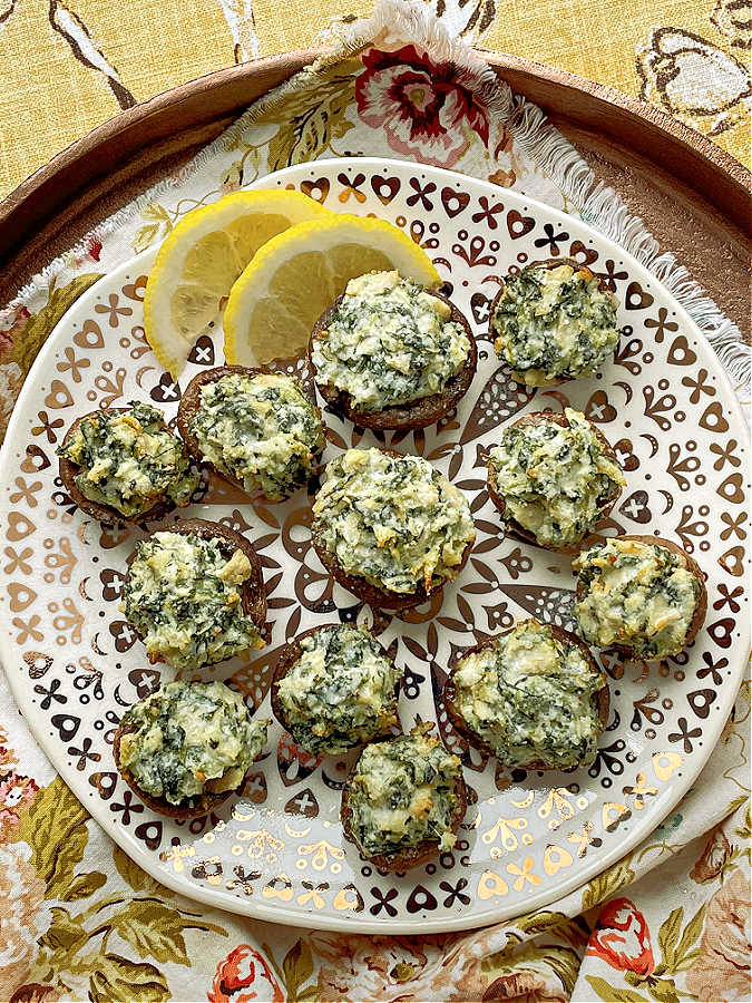 stuffed mushrooms on a plate with lemon slices