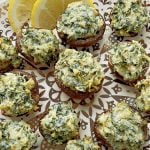 air fryer stuffed mushrooms on a plate with lemon slices