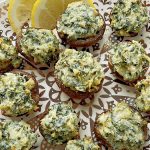 air fryer stuffed mushrooms on a plate with lemon slices