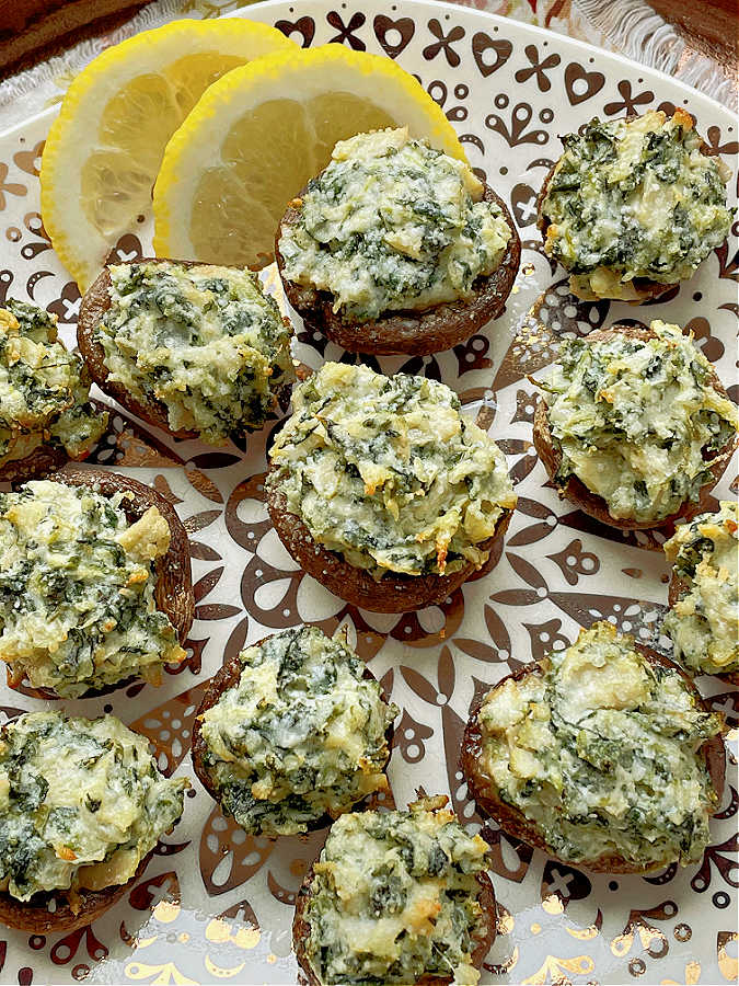 air fryer stuffed mushrooms on a plate with lemon slices