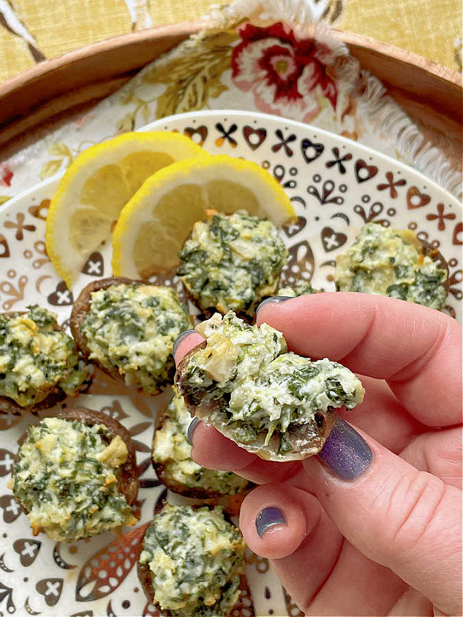 taking a bite of a stuffed mushroom