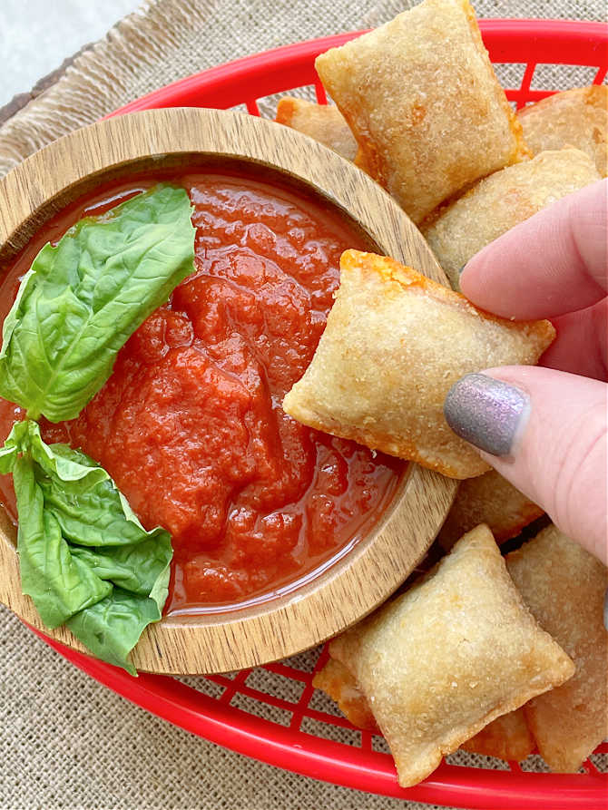 dipping a pizza roll in marinara sauce