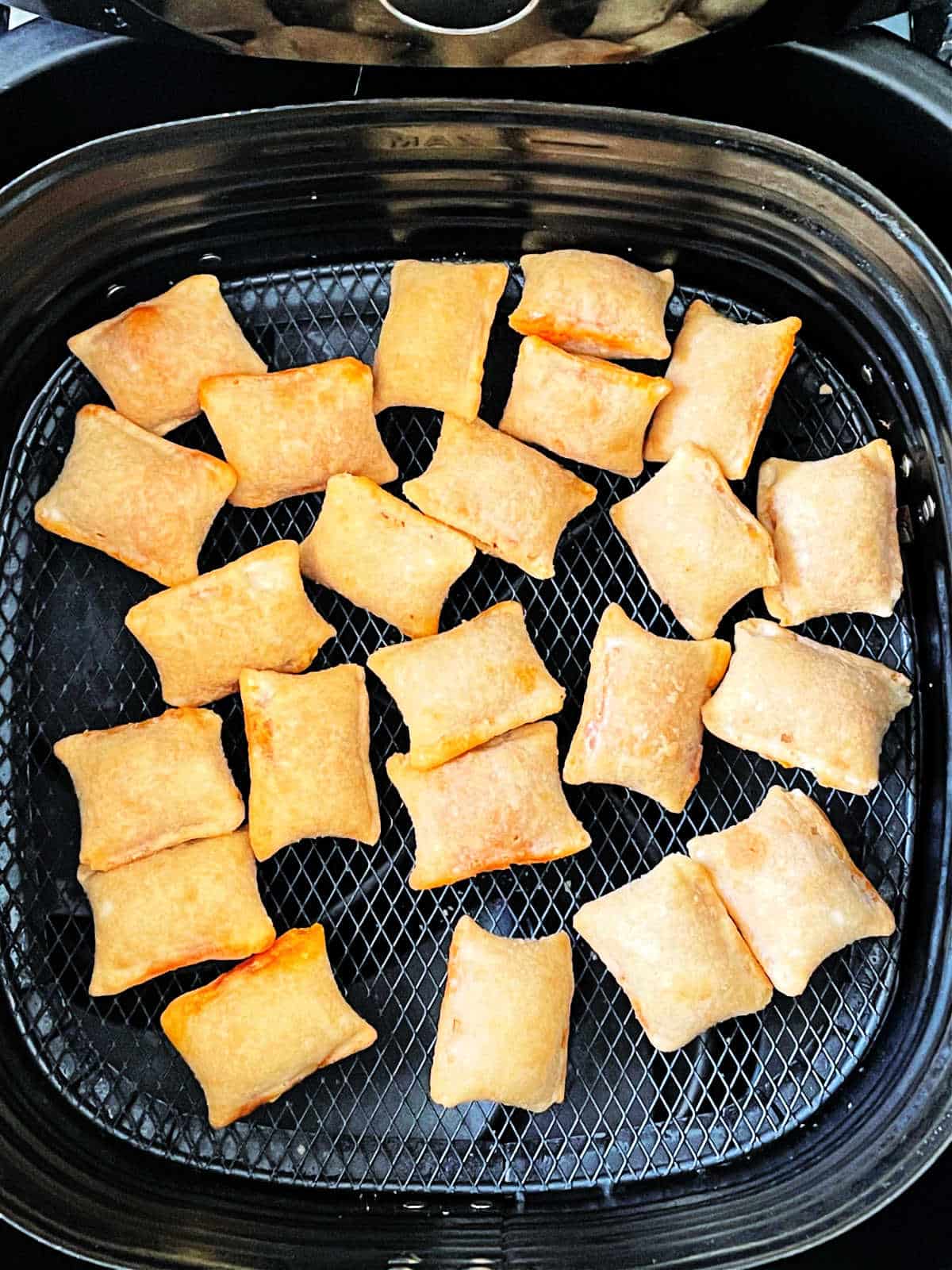 pizza rolls in a single layer in the air fryer basket
