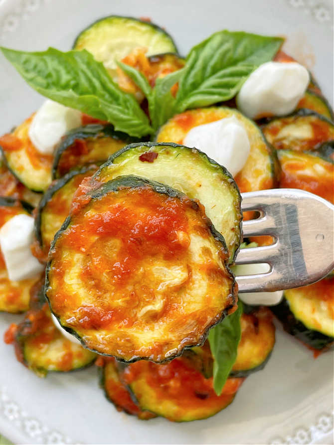 taking a bite of air fryer zucchini