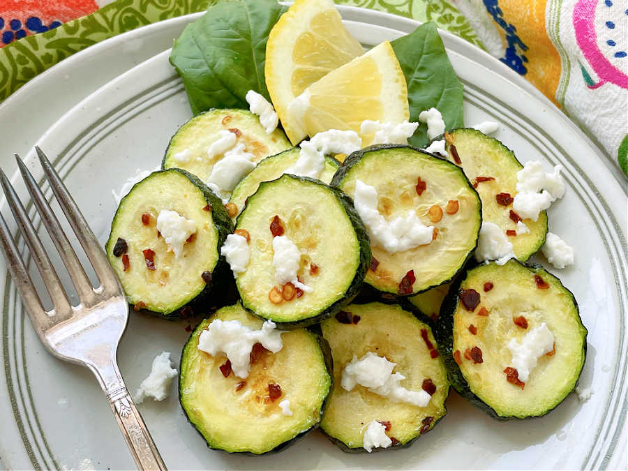 air fryer zucchini slices topped with lemon and fresh mozzarella