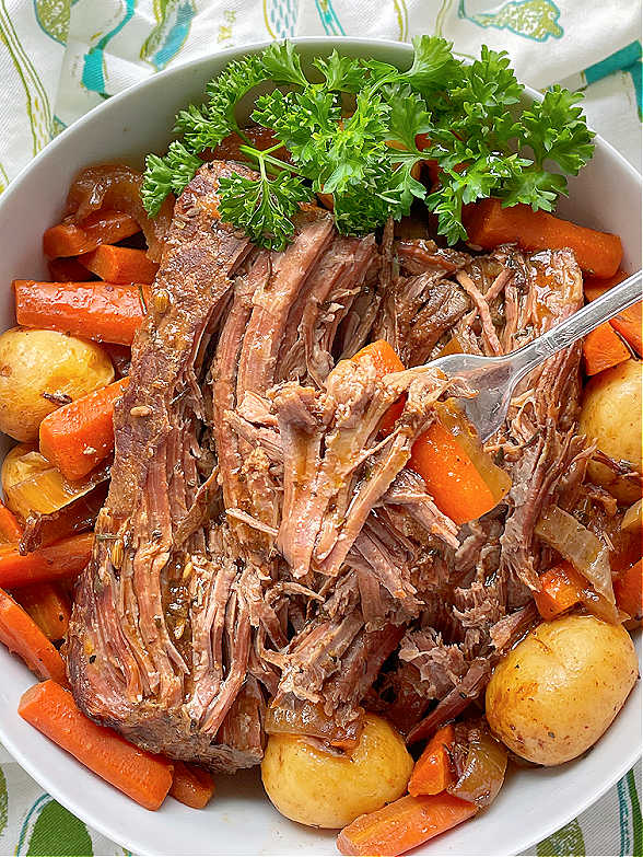 taking a bite of slow cooker sirloin tip roast