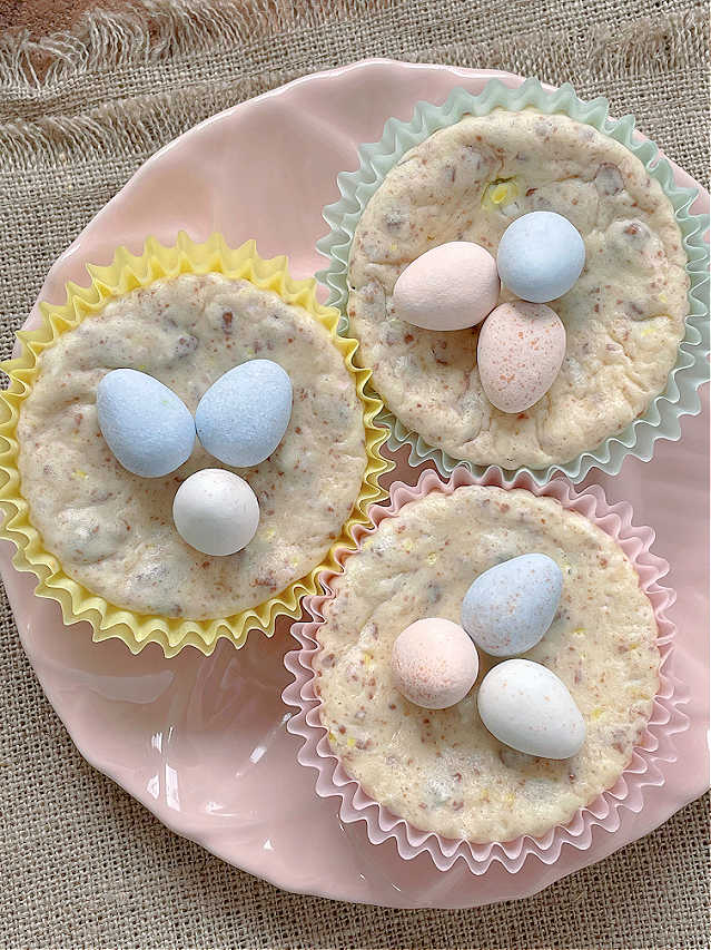 three mini egg cheesecakes on a pink plate