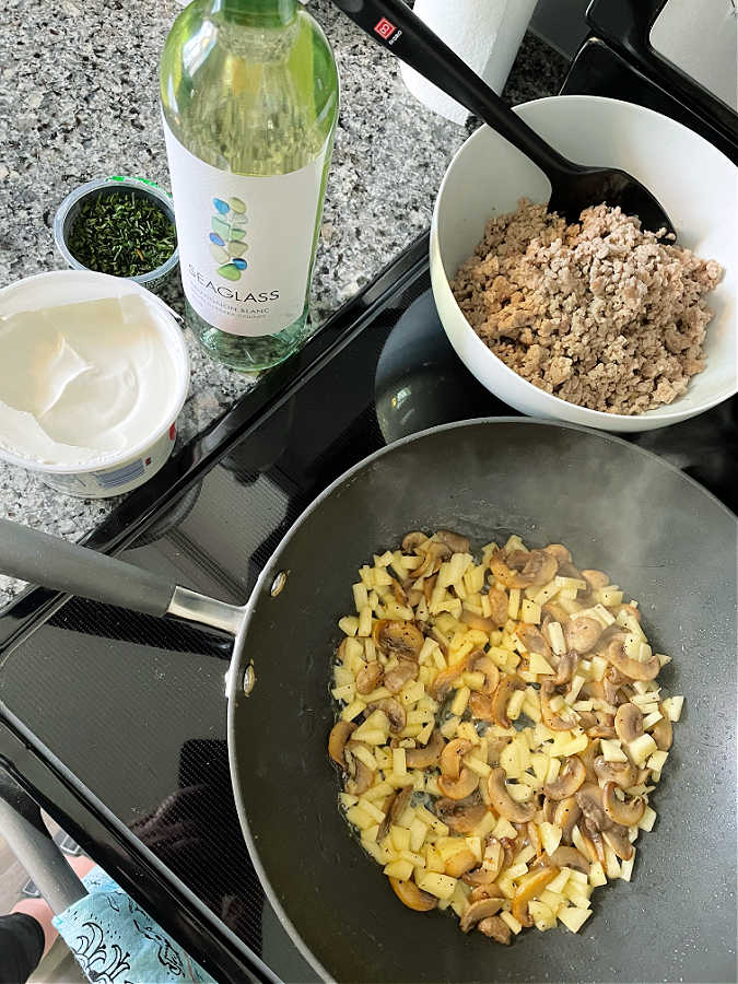 showing the pork stroganoff cooking on the stove top