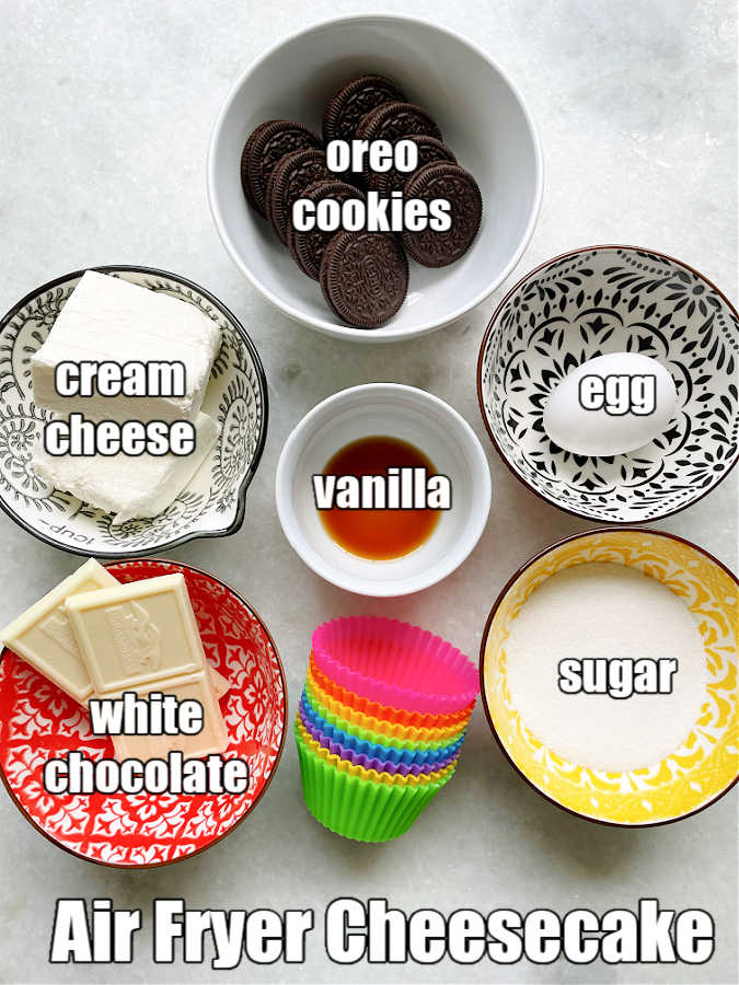 picture of ingredients for air fryer cheesecake - oreos, cream cheese, sugar, egg, white chocolate and vanilla