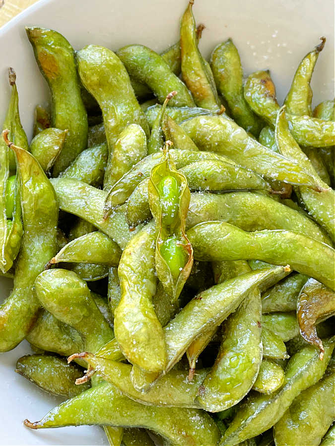 a bowl of roasted air fryer edamame