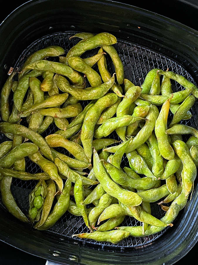 roasted edamame in the basket of the air fryer