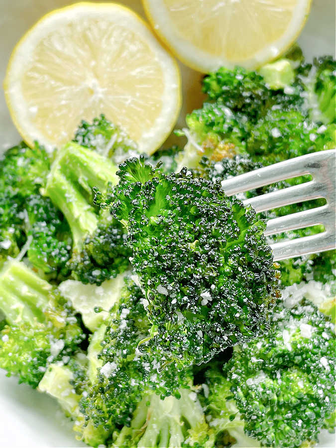 taking a bite of air fried broccoli