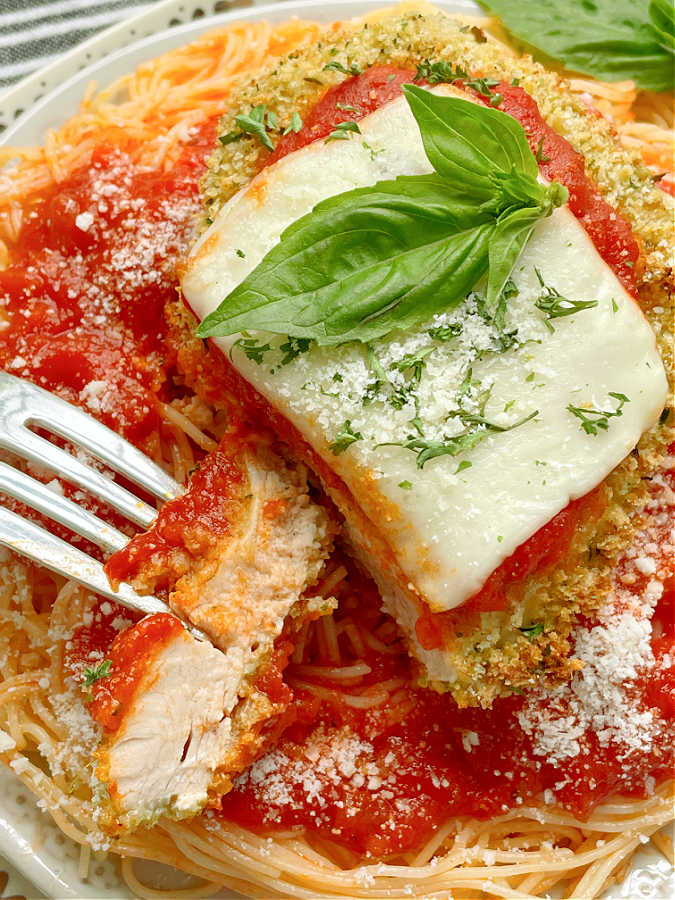 taking a bite of air fryer chicken parmesan