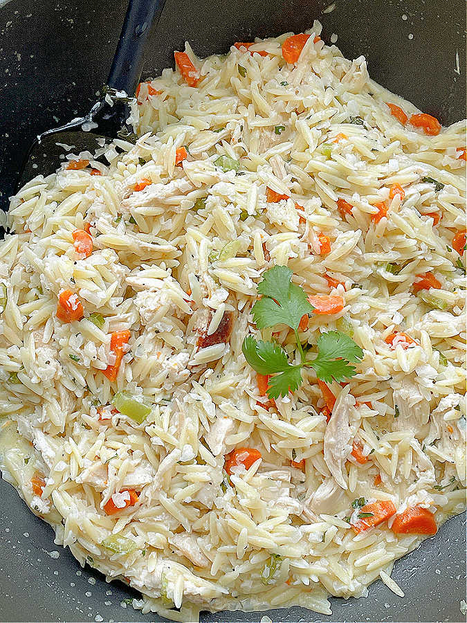 making creamy chicken risoni in a frying pan