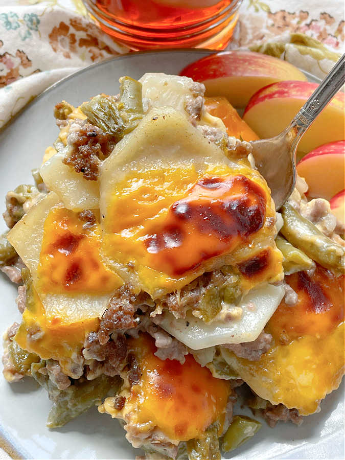 taking a bite of hamburger potato casserole