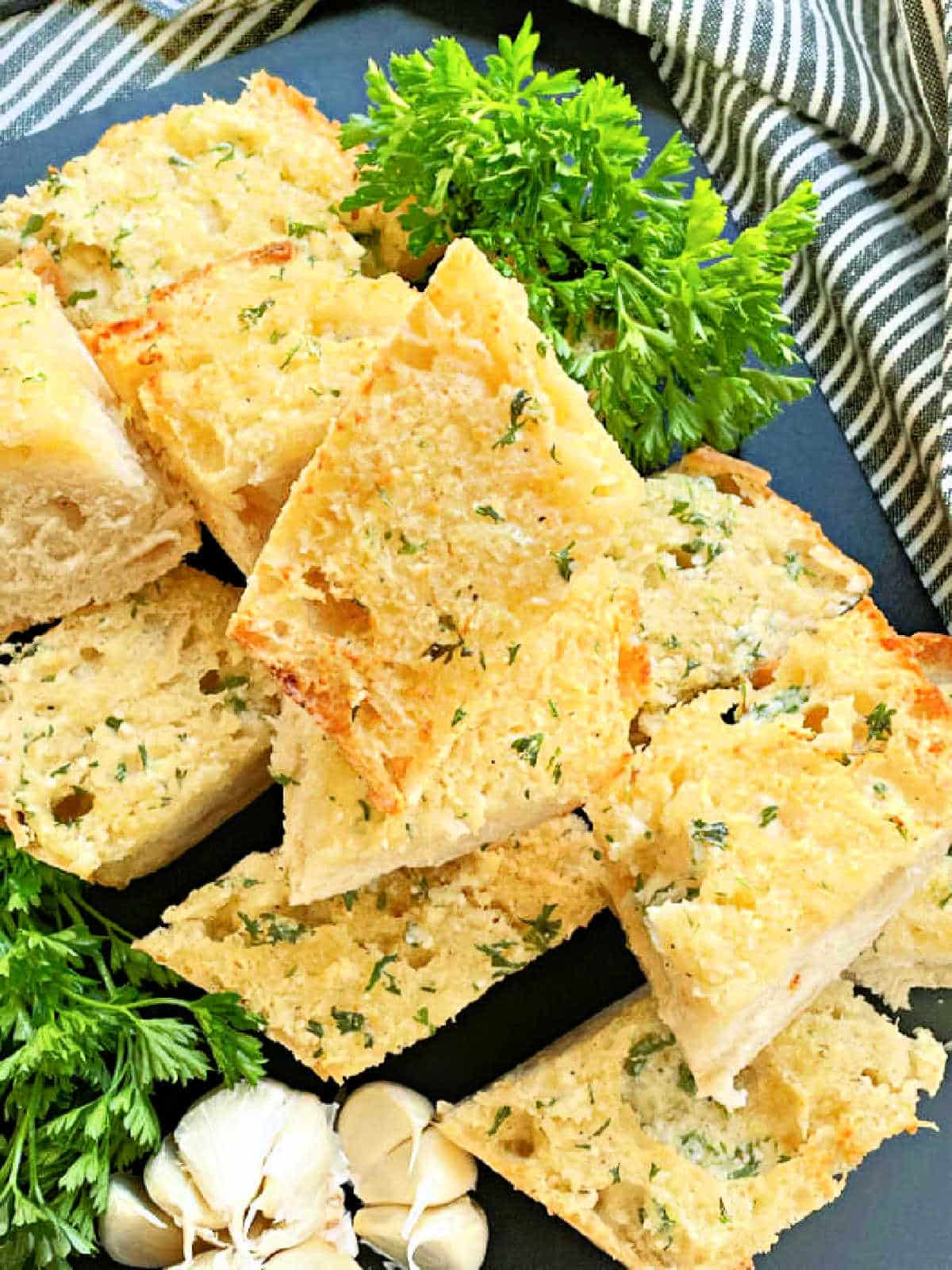 sliced air fryer garlic bread on a black cutting board