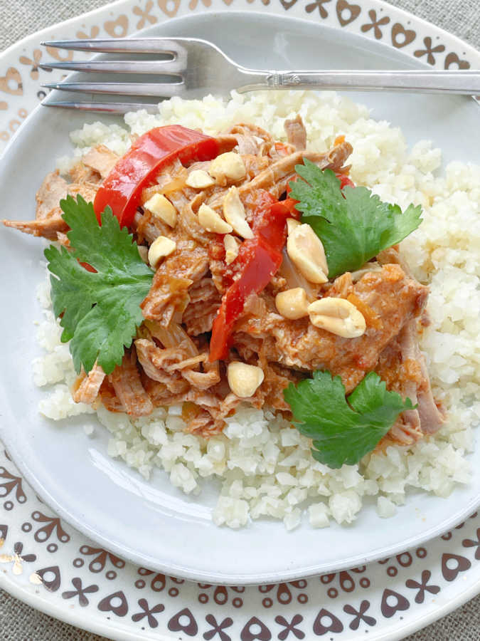 slow cooker satay pork served over cauliflower rice