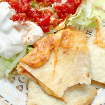 a cheesy slice of air fried quesadilla with a bite taken out of it