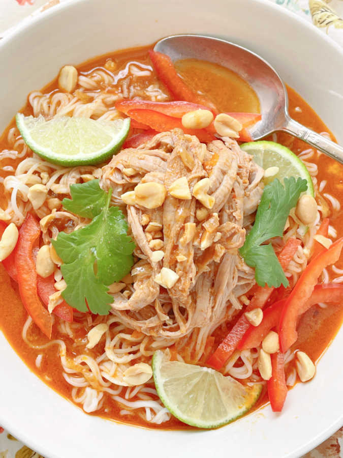 close up view of slow cooked pork on top of the thai ramen