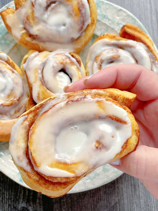 showing a frosted cinnamon roll up close