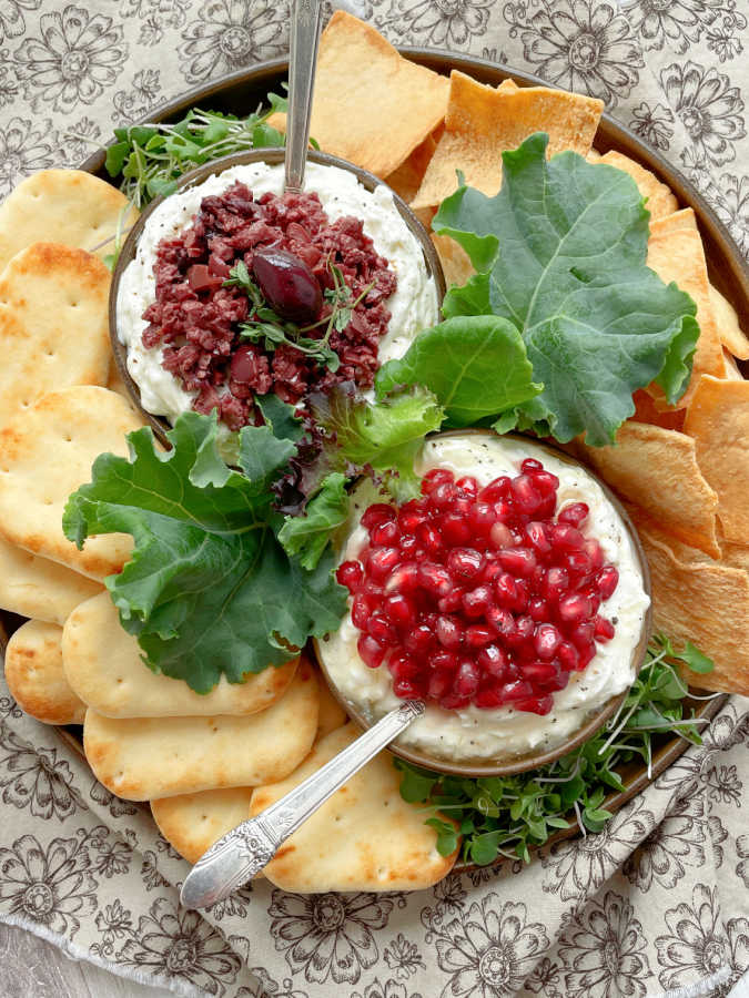 a beautiful platter of greek feta dip, two ways, with naan dippers and pita chips to dip