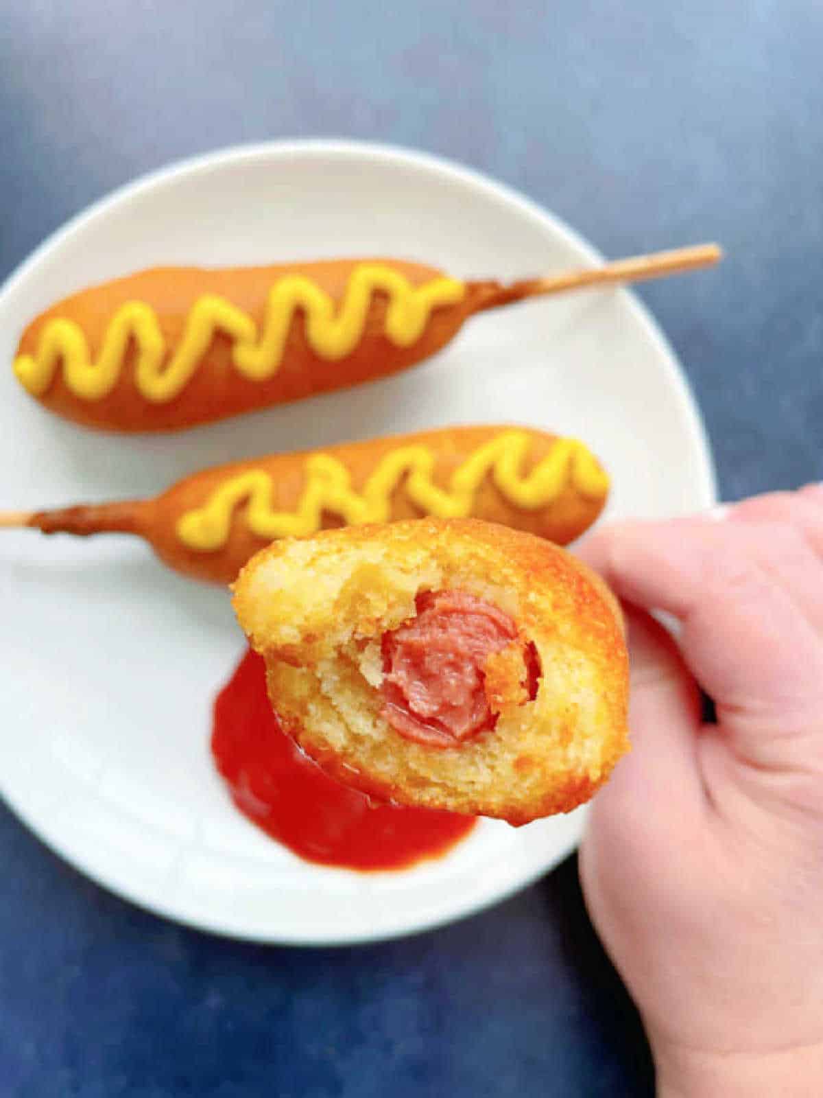 showing a corn dog with a bite taken out of it