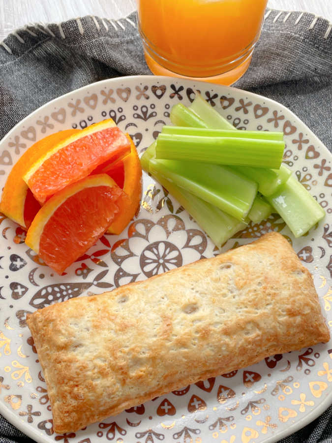air fryer hot pocket plated with celery and orange slices