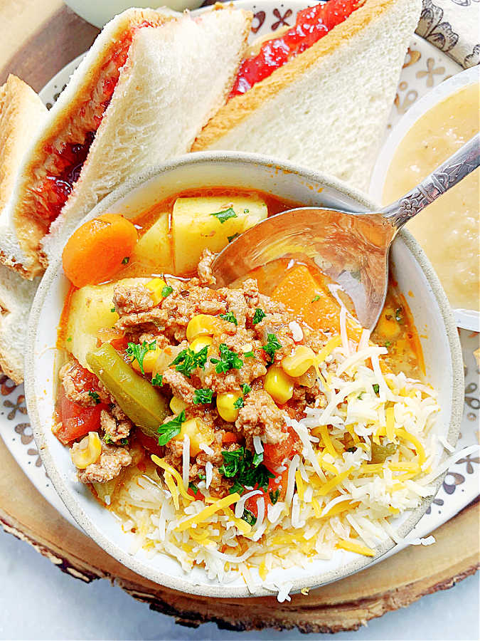 campfire stew in a bowl with a spoon