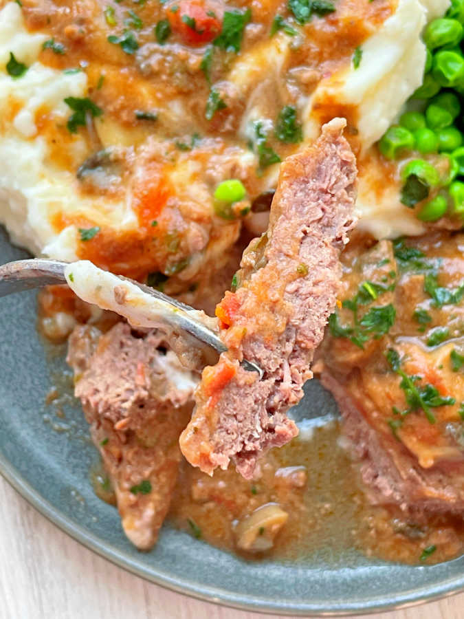 taking a bite of crock pot cube steak