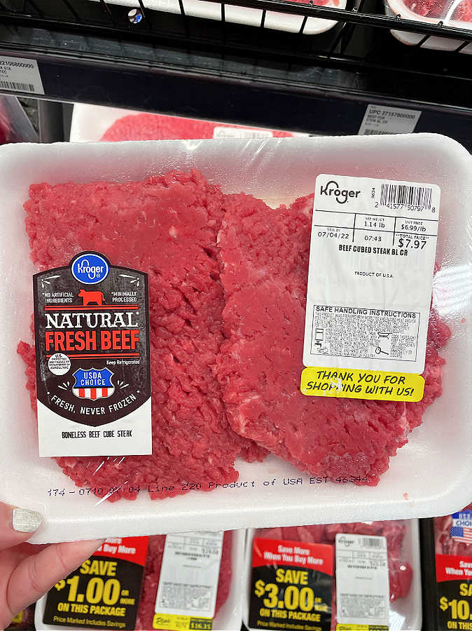 showing a package of cube steak in the packaged meat section at the grocery store