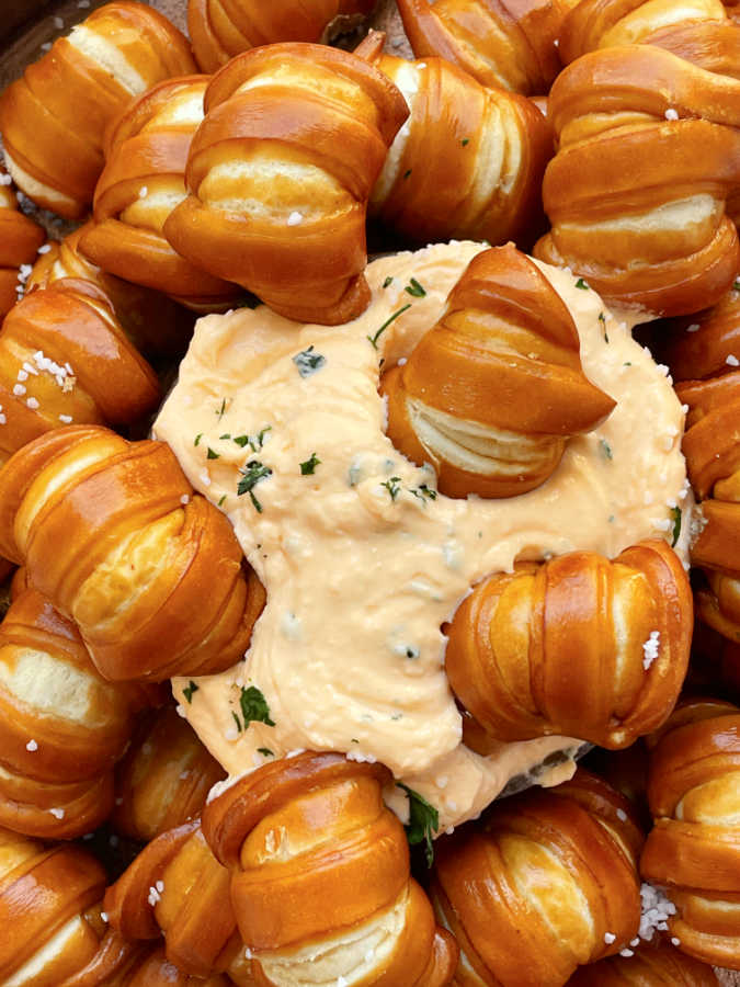 dipping pretzel bites into the pub cheese